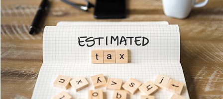 Wooden letter tiles spelling estimated tax