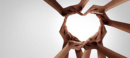 Diverse hands making a heart