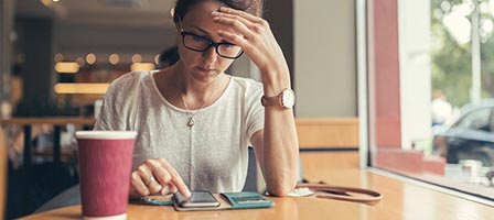 Woman using smartphone in a café