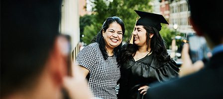 Graduate and mother smiling outdoors