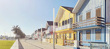 Brightly painted beach houses in a row.