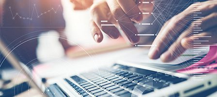 Hands typing on a laptop keyboard