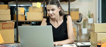Entrepreneur managing online orders on computer