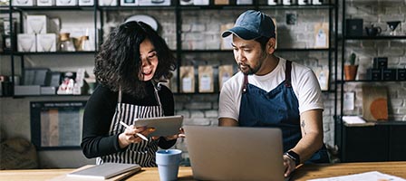 Two people collaborating in a coffee shop