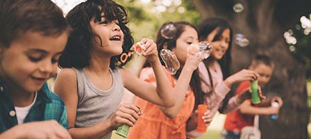 Group of children playing with bubbles