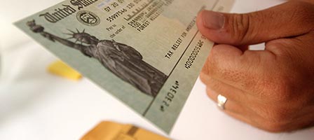 Hands holding a U.S. Treasury check