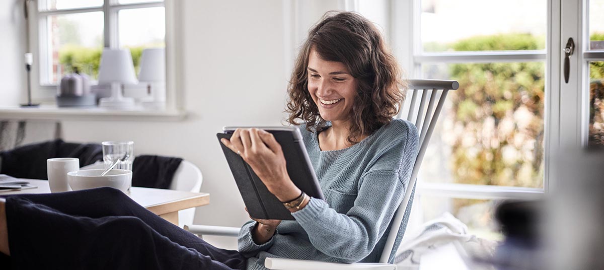 Relaxed woman with book near window