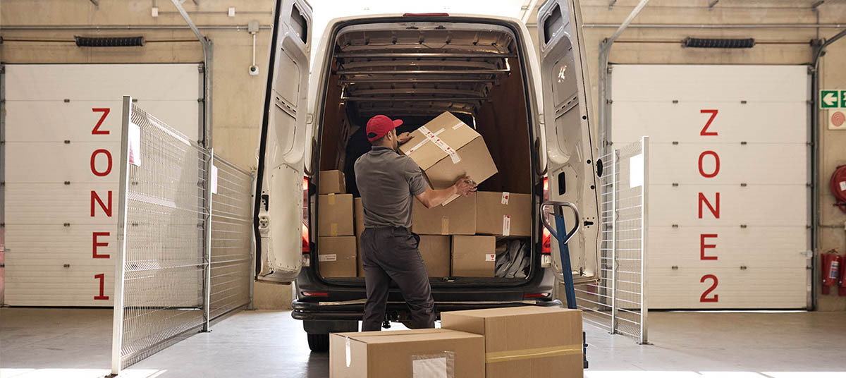 Warehouse worker organizing shipment boxes