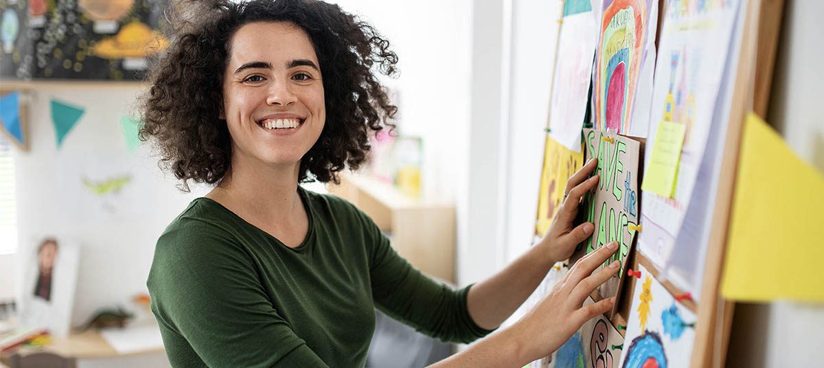 Woman decorating colorful bulletin board