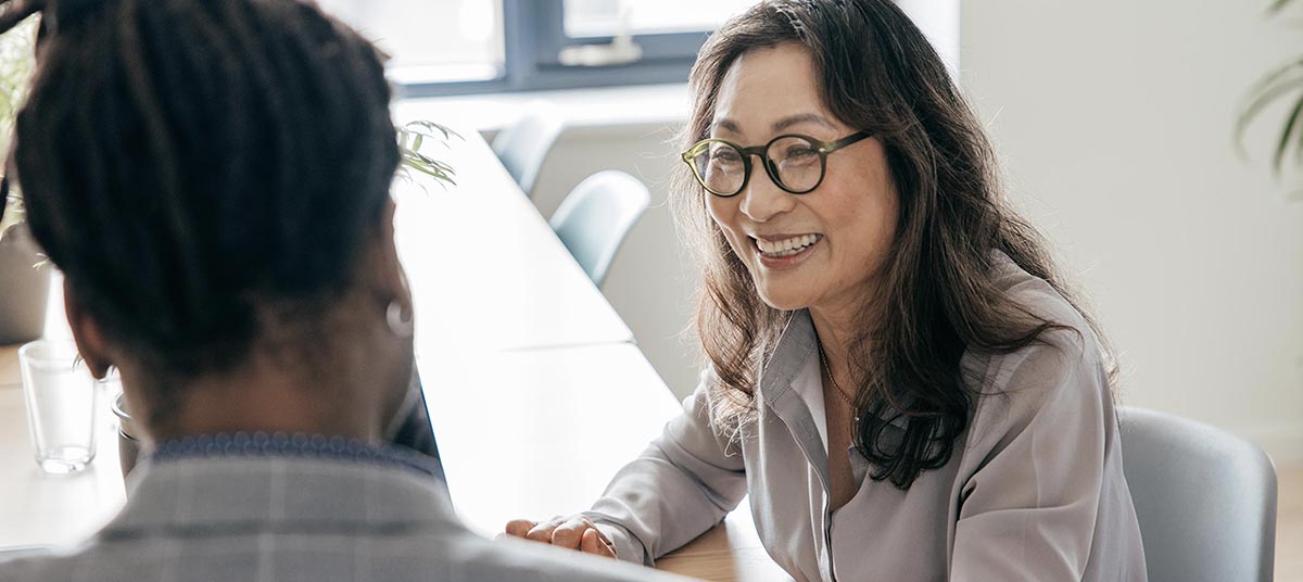 Business meeting with two people smiling