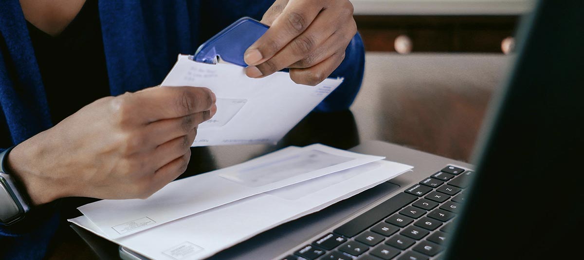 Opening mail near a laptop