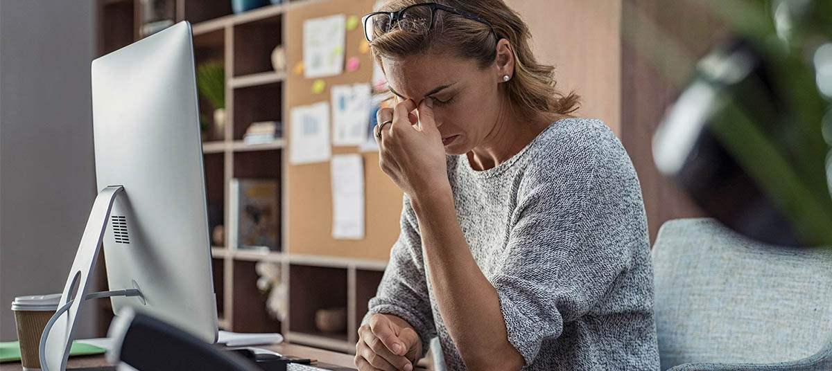 Woman stressed at computer desk