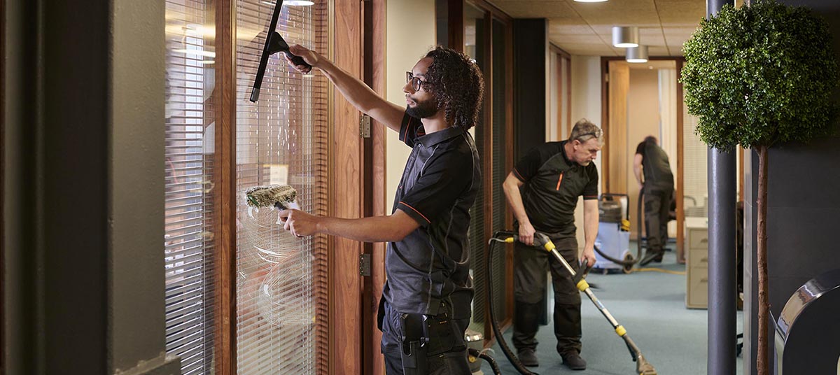 Workers cleaning office windows and floors