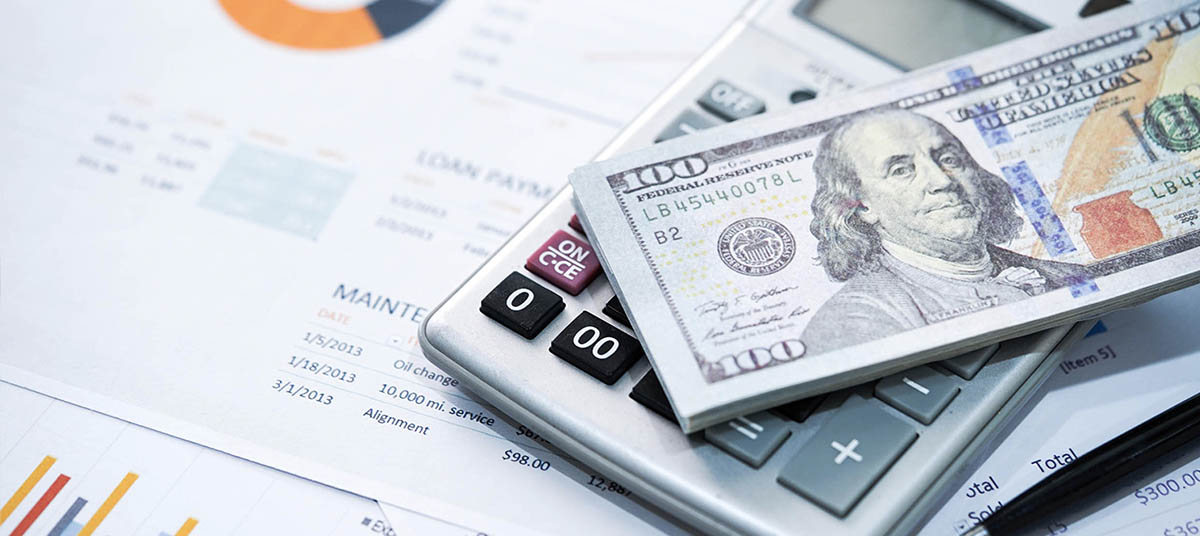 Financial planning with calculator and cash