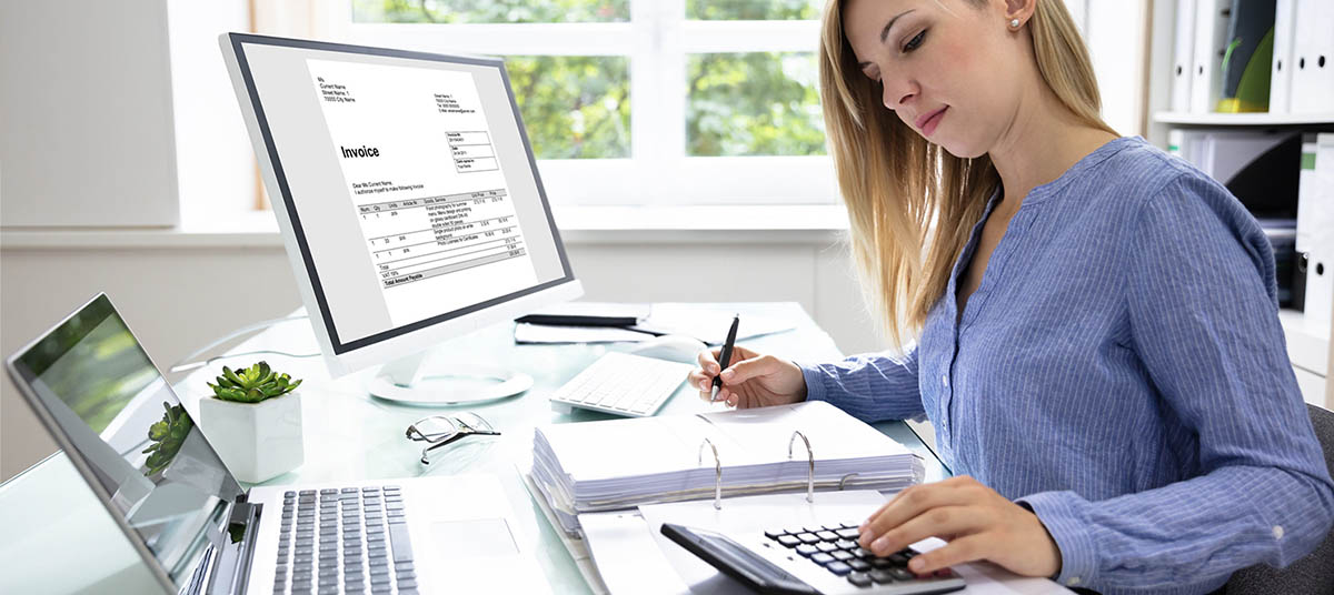 Woman working at desk with calculator