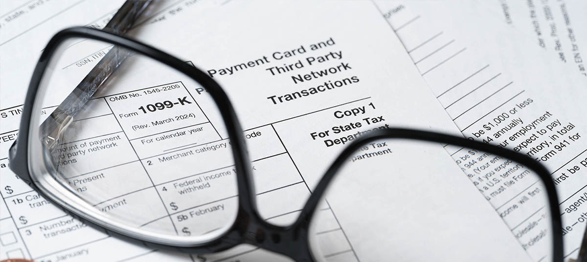 Financial papers beneath reading glasses