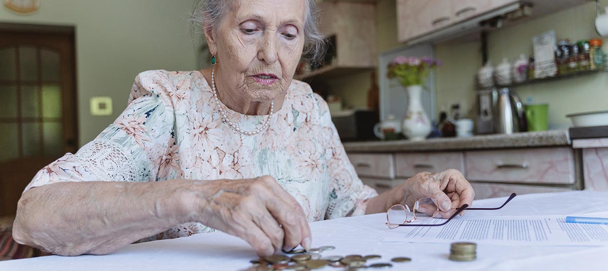 Woman handling money beside paperwork