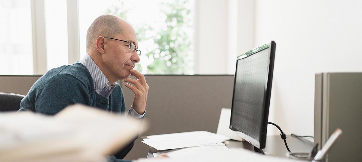 Office worker concentrating on monitor