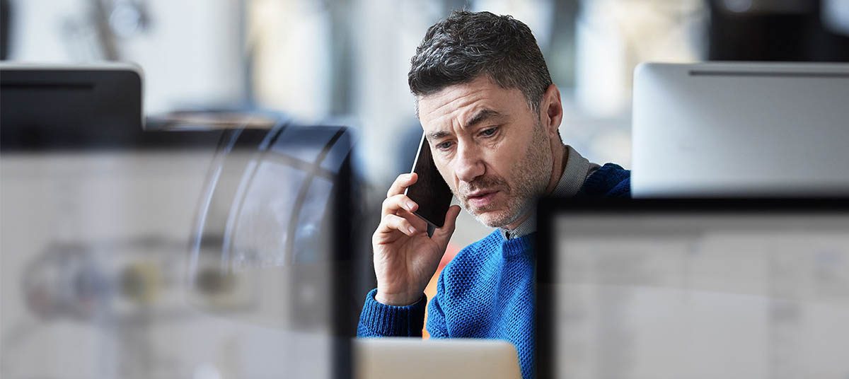 Man talking on phone in office