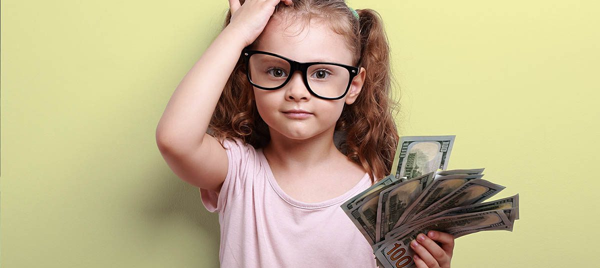 Little girl with glasses holding money