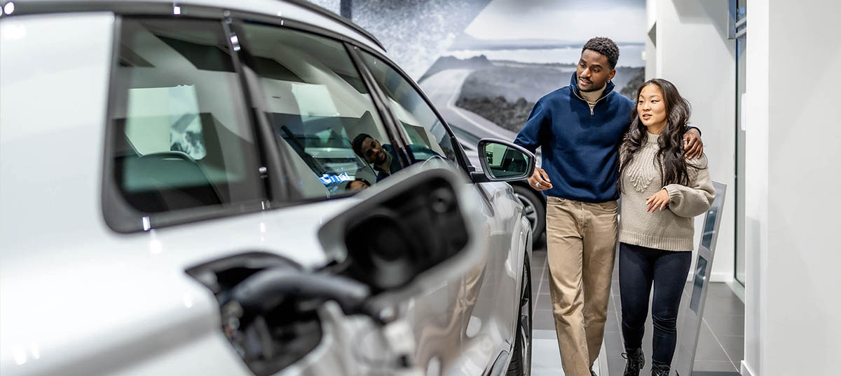 Pair exploring car dealership showroom
