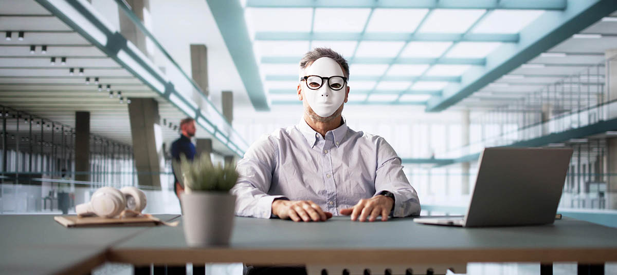 Professional workspace with masked employee.