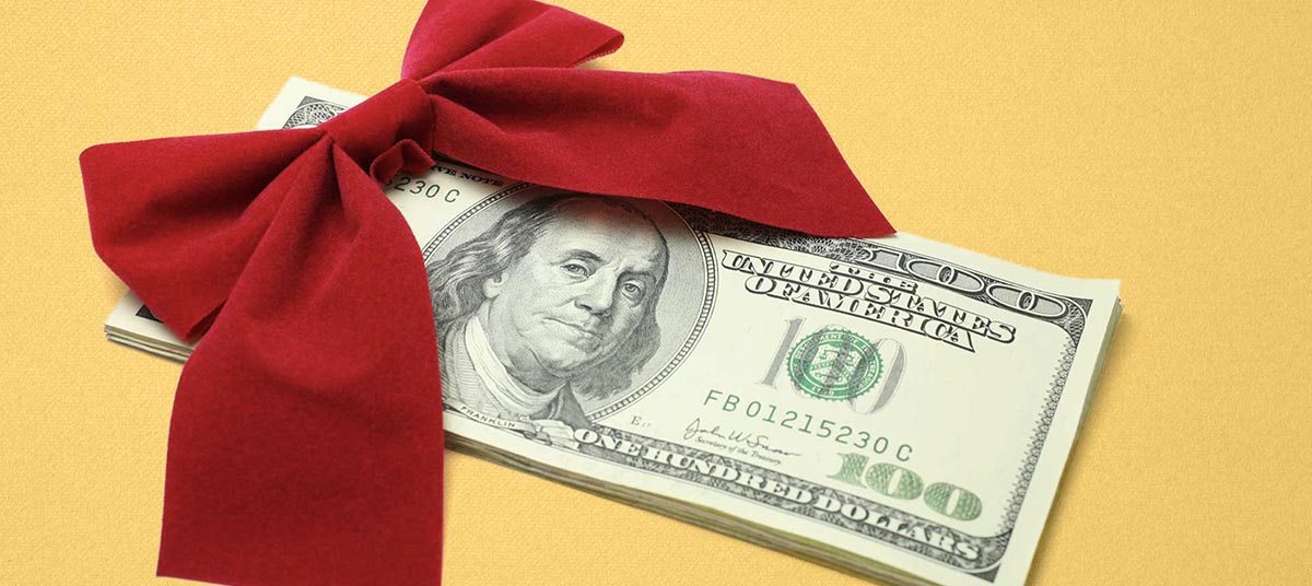 Stack of money wrapped in bow