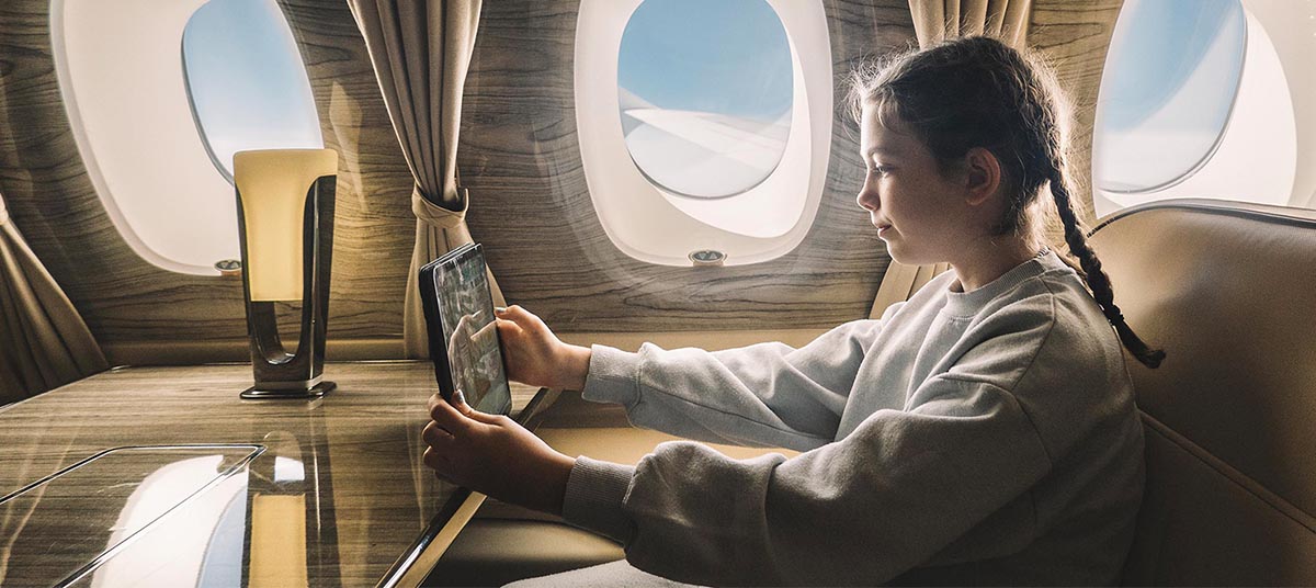 Child with braids seated in aircraft