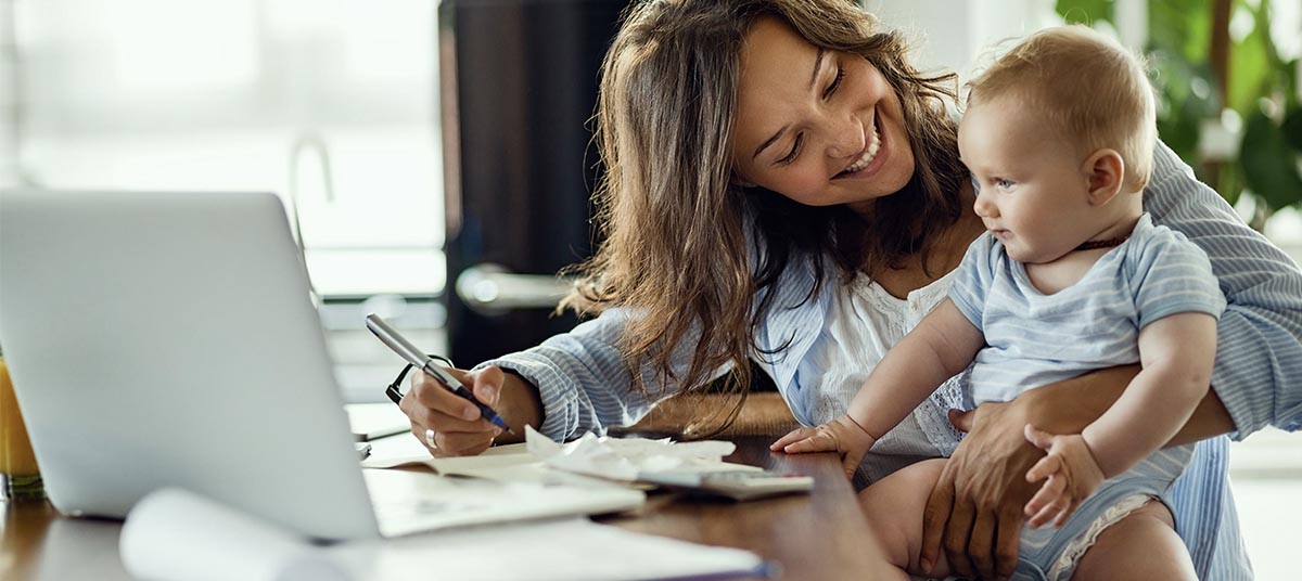 Woman working from home with baby