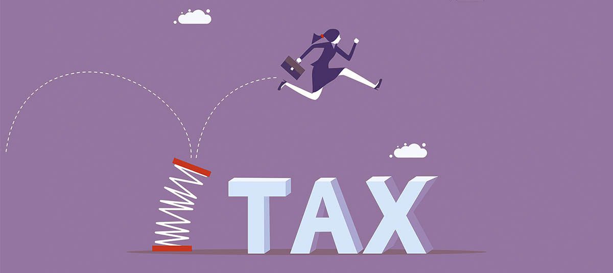 Person leaping over tax obstacle