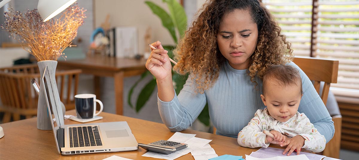 Woman working at home with baby