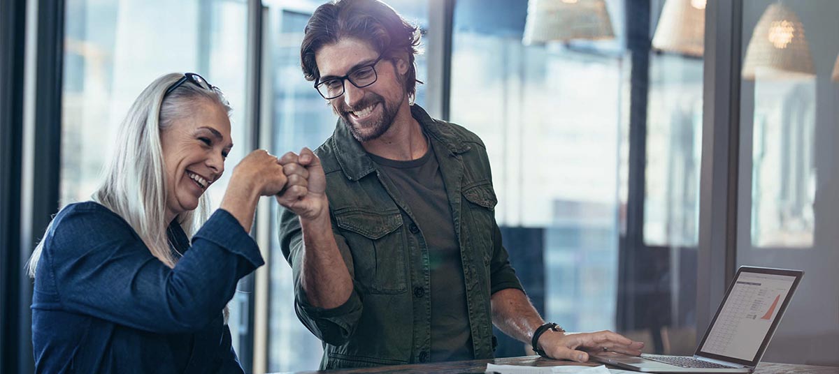 Happy coworkers celebrating a success together