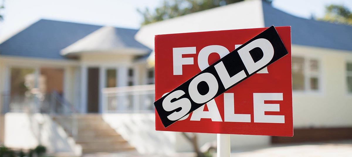 House with sold sign in front yard