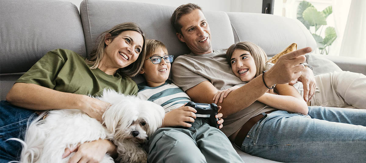 Parents and children smiling on couch