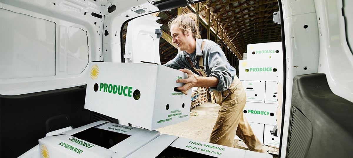 Loading produce boxes into van