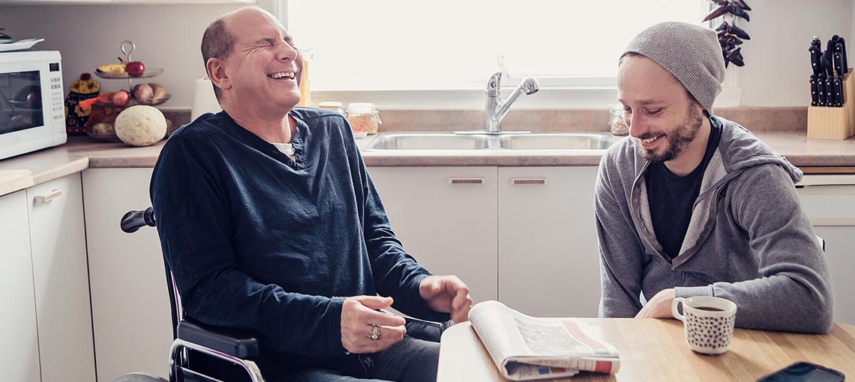 Two men laughing in the kitchen