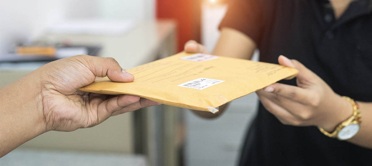 Envelope being passed between two people