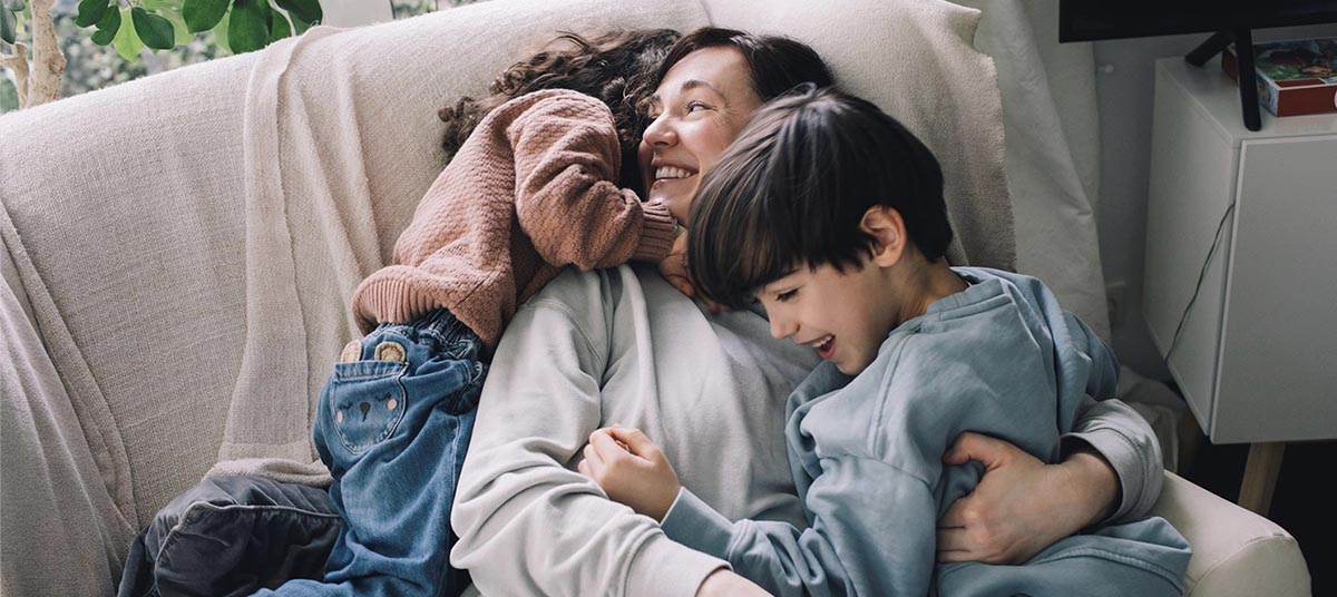 Family cuddling on a cozy sofa
