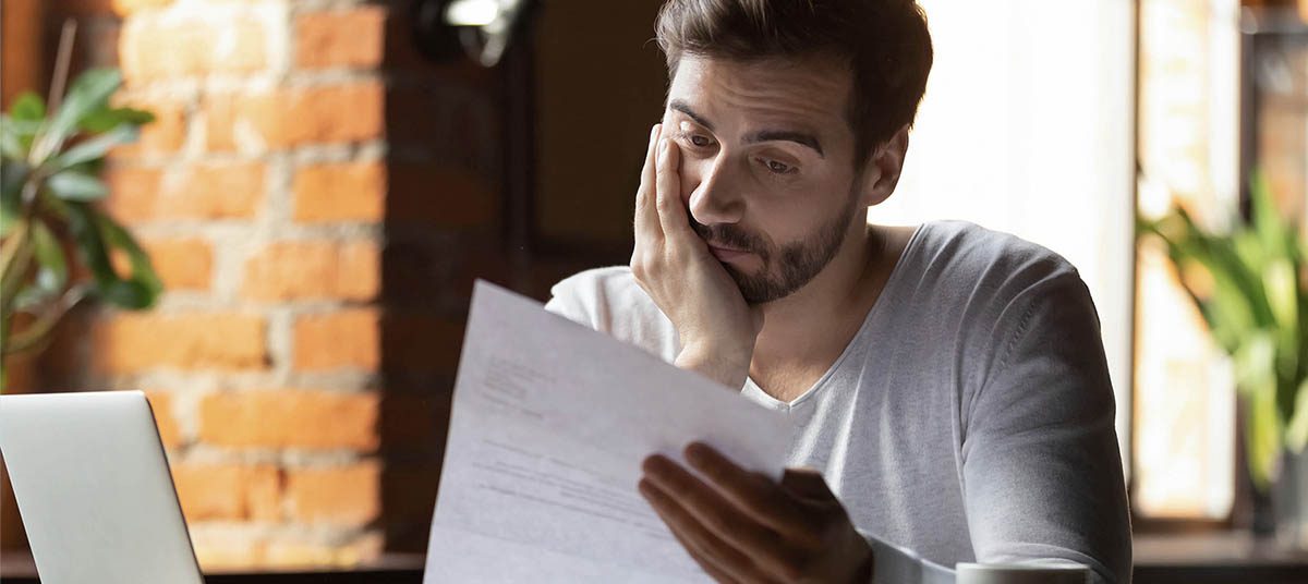Individual reviewing papers thoughtfully