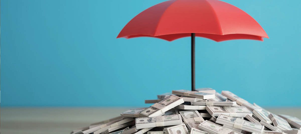 Money covered by red umbrella