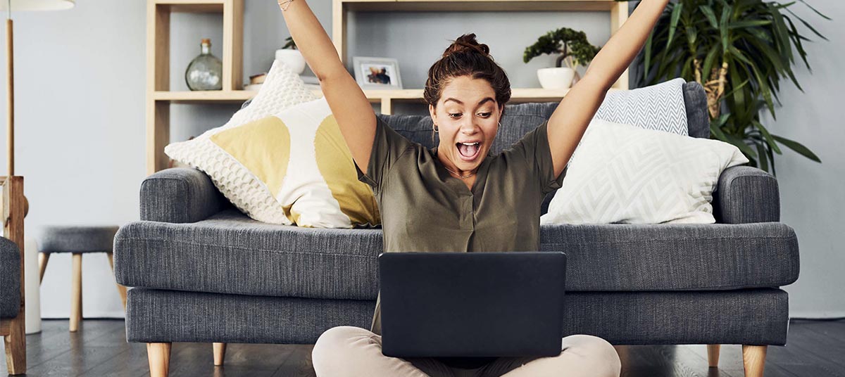 Woman celebrating success with laptop