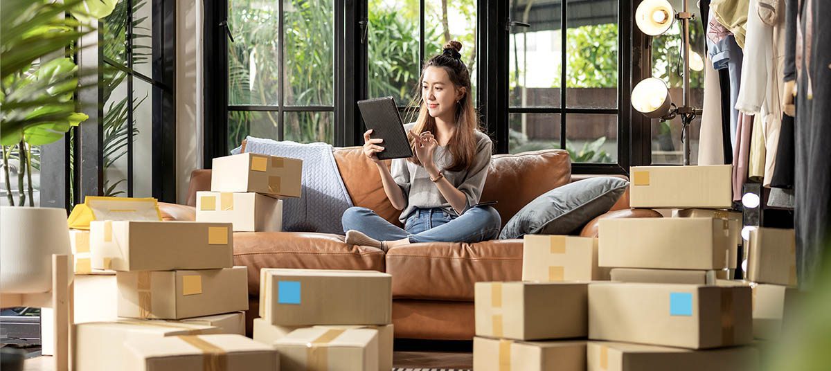 Online business owner surrounded by boxes