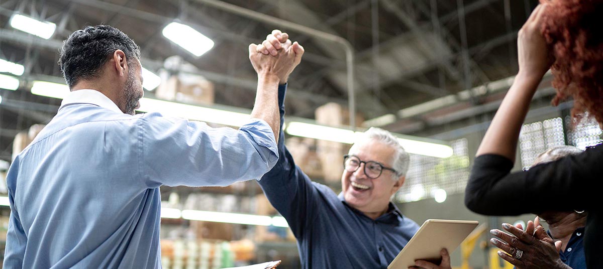 Workers cheering and applauding teamwork