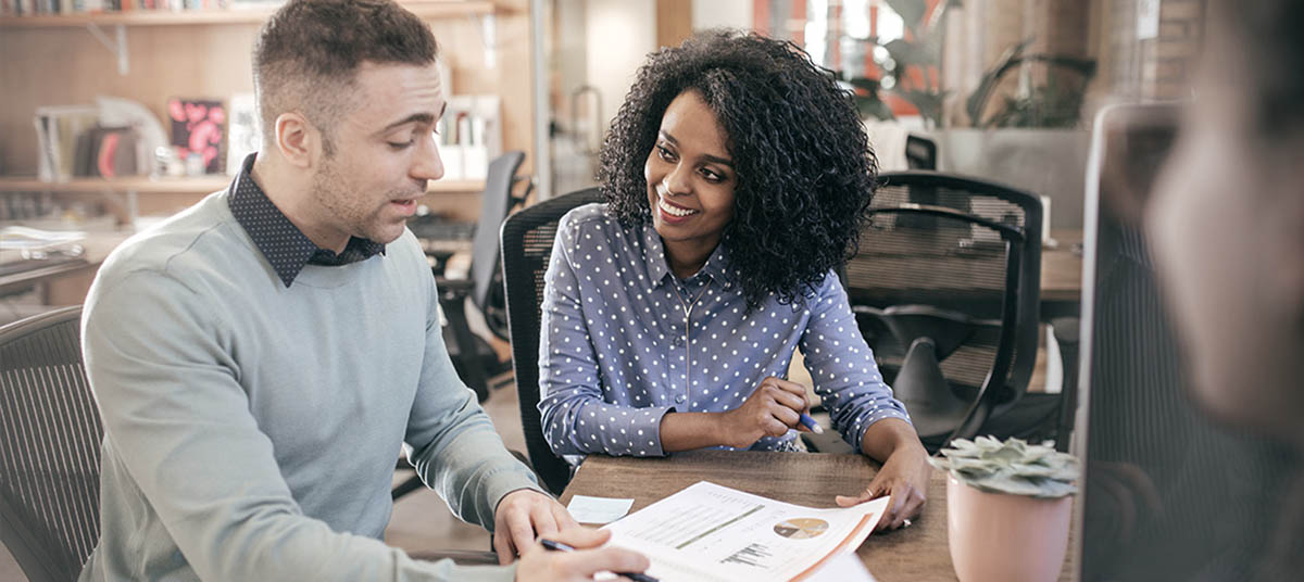 Coworkers collaborating at a desk