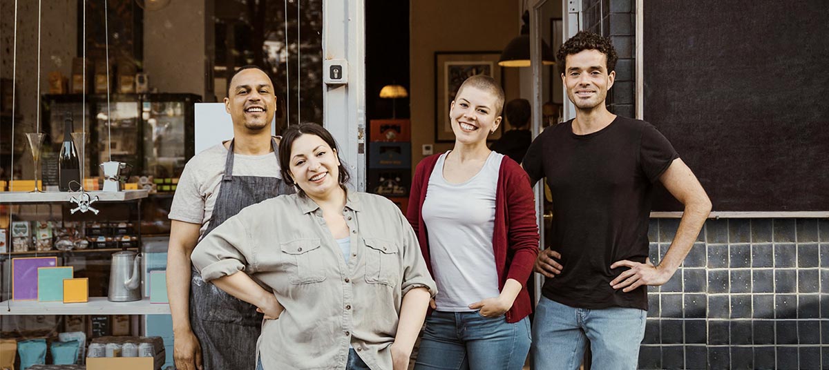 Happy group posing at storefront