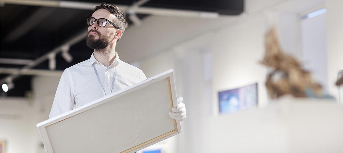 Art gallery worker with canvas