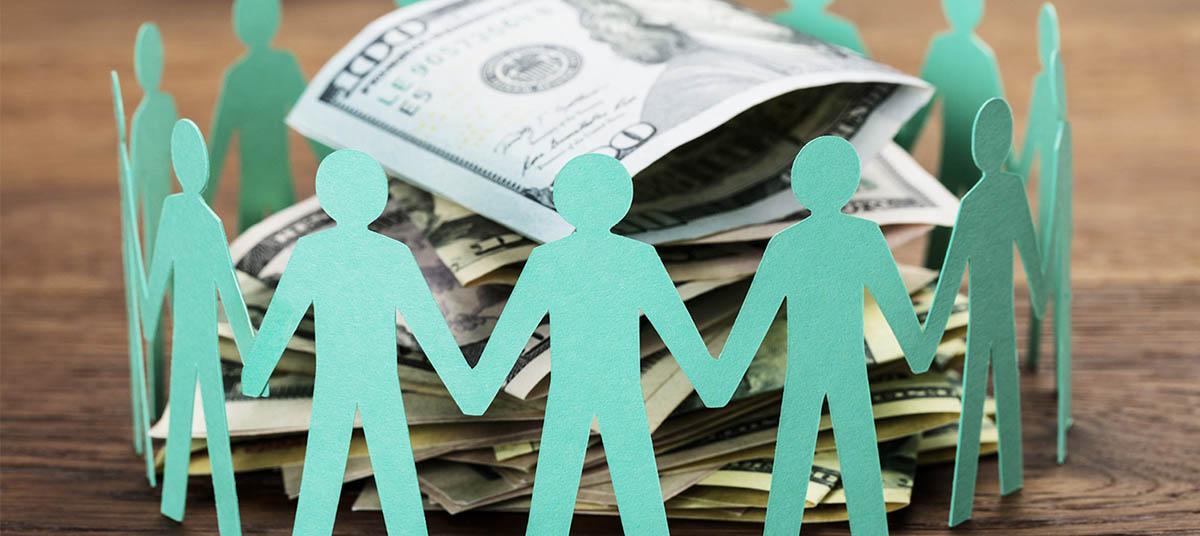 Paper figures around money pile