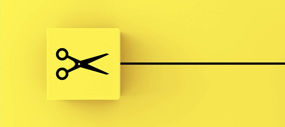 Black scissors symbol on yellow paper
