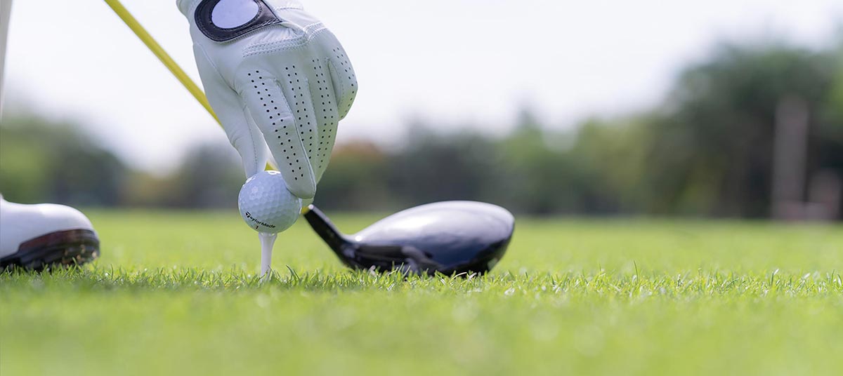 Preparing to drive golf ball