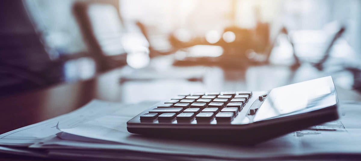 Office desk with calculator and papers